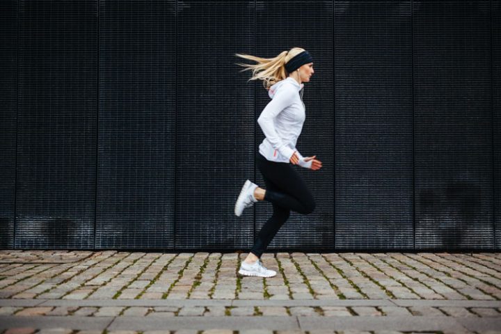 Young woman wearing workout gear and running